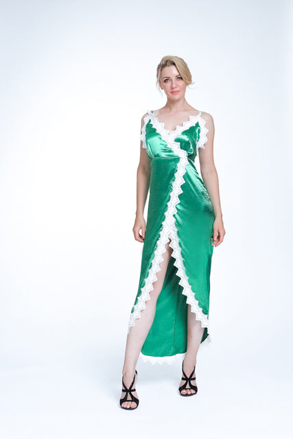 A woman wearing a sexy green satin midi dress with lace details