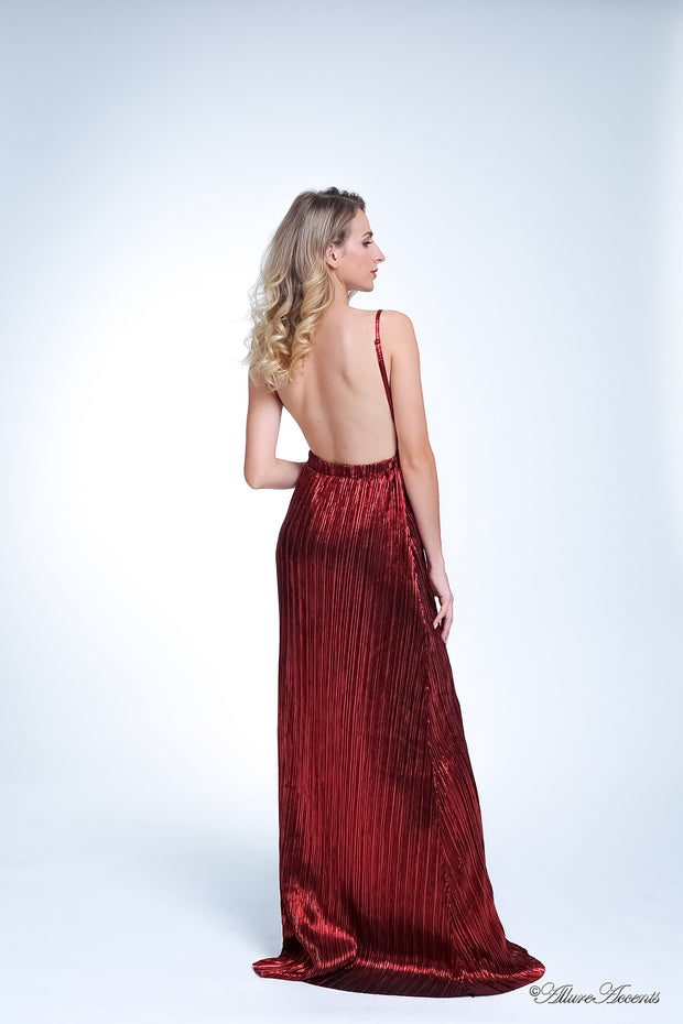 Woman wearing a red colored maxi length slip dress with a deep v neck.