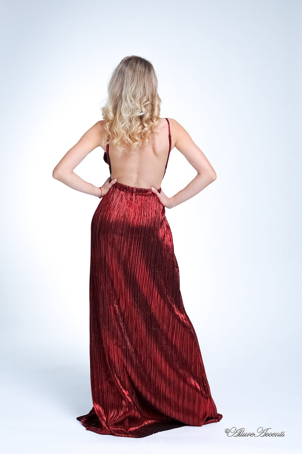 Woman wearing a red long maxi length slip dress showing it has a low back cut.