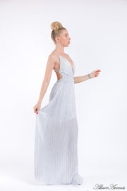 Woman wearing a white colored maxi length slip dress with a deep v neck.