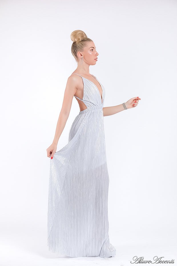 Woman wearing a white colored maxi length slip dress with a deep v neck.
