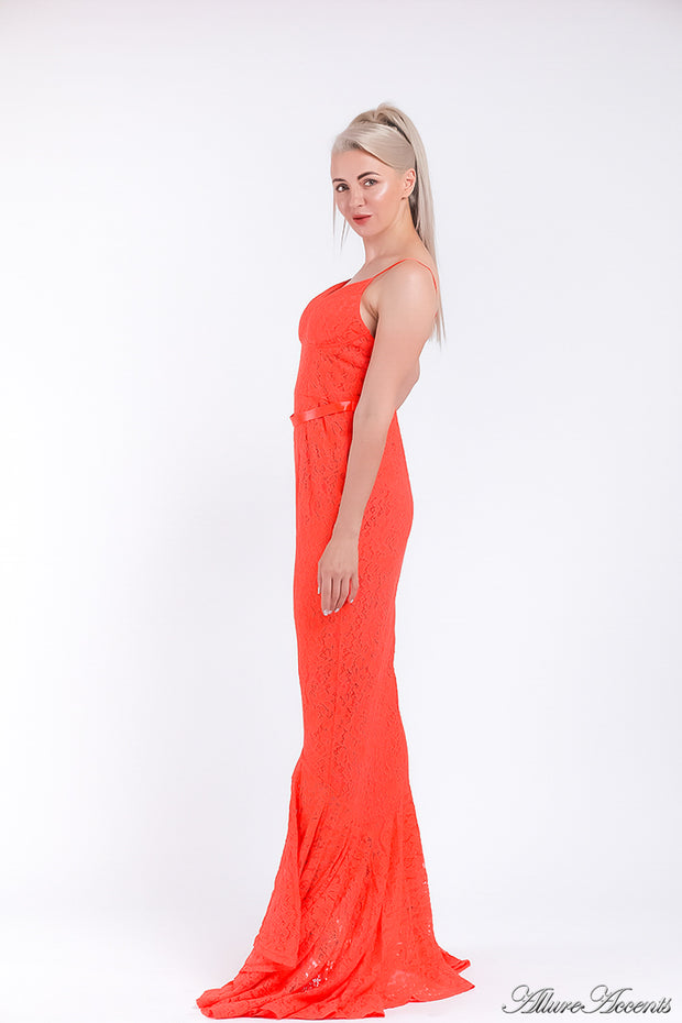 Woman wearing an orange high-low floral lace dress.