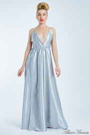 Woman wearing a silver long satin dress that has a deep v neckline.