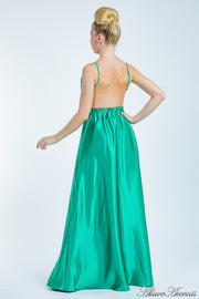Woman wearing a jade green long satin dress that has a deep v neckline.