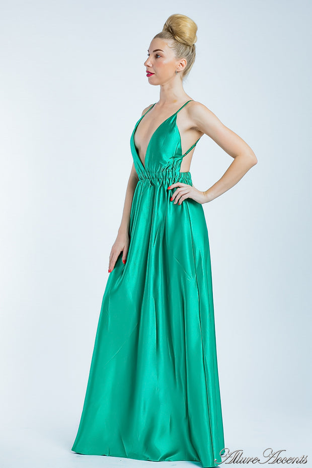 Woman wearing a jade green long satin dress that has a deep v neckline.