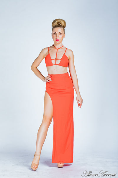 Woman is wearing a red party 2 pieces outfit, sexy summer crop top and side slit long skirt