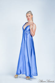 Woman wearing a royal blue long satin dress that has a deep v neckline.