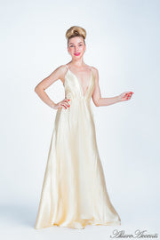 Woman wearing a carmel long satin dress. 
