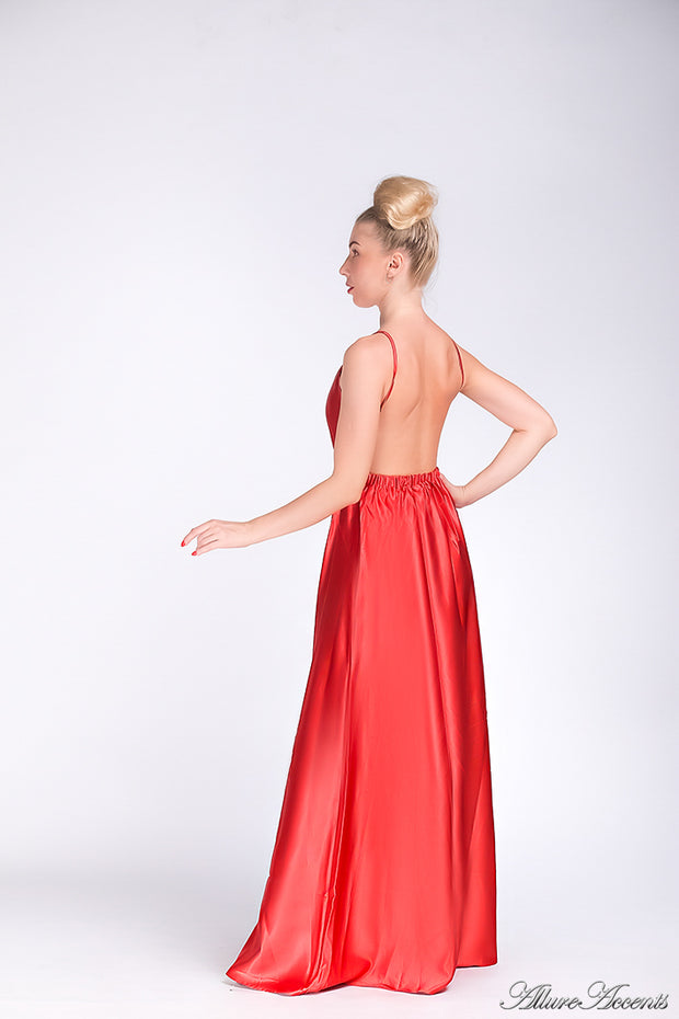 Woman wearing a bronze red long satin dress that has a deep v neckline.