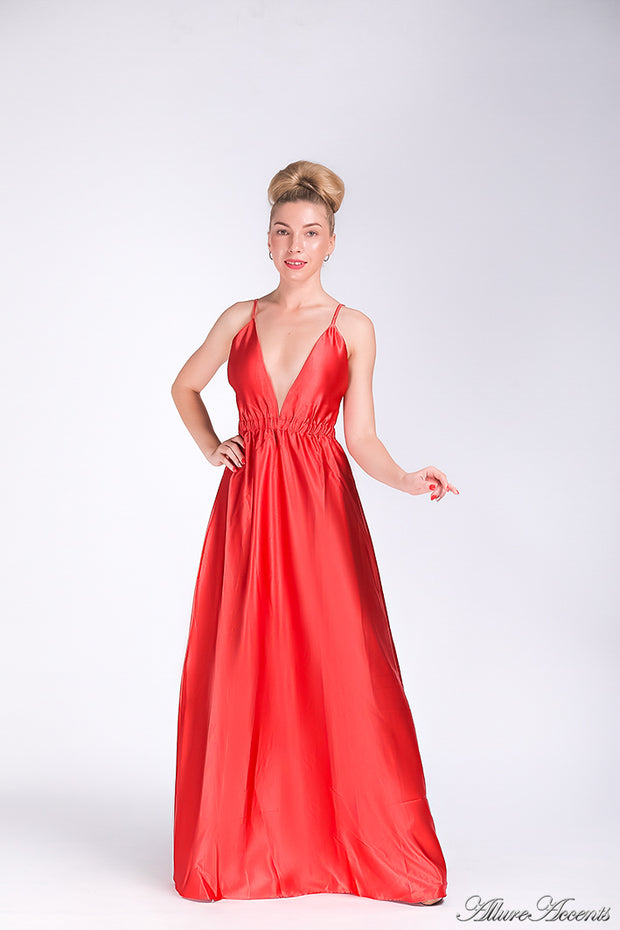 Woman wearing a bronze red long satin dress that has a deep v neckline.
