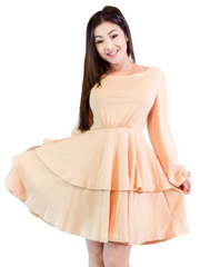 Woman is wearing a beige mini layers dress, casual long sleeves dress appropriate for all seasons 