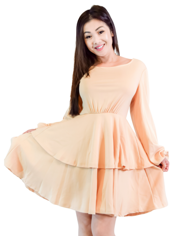 Woman is wearing a beige mini layers dress, casual long sleeves dress appropriate for all seasons 