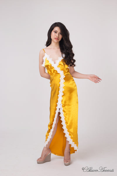 A woman wearing a sexy gold satin midi dress with lace details