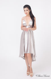 Woman wearing summer silver grey satin party dress, hi-low style with chest paddings