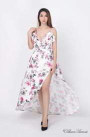 Women is wearing a white multi color floral maxi dress, sexy satin floral sundress with low-cut back with ruffles detail 