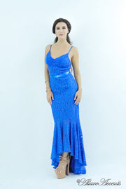 Woman wearing a royal blue high-low floral lace dress.