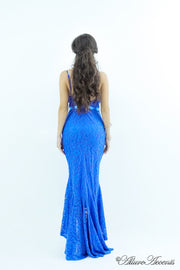Woman wearing a royal blue high-low floral lace dress.