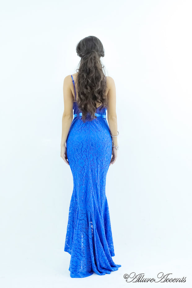 Woman wearing a royal blue high-low floral lace dress.
