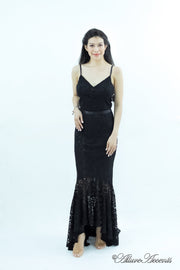 Woman wearing a black colored high-low floral lace dress.
