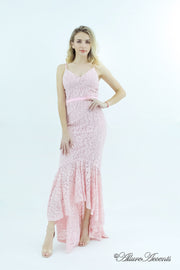 Woman wearing a baby pink high-low floral lace dress.