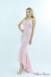 Woman wearing a baby pink high-low floral lace dress.