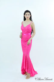 Woman wearing a barbie pink high-low floral lace dress.