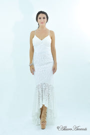 Woman wearing a white colored high-low floral lace dress.