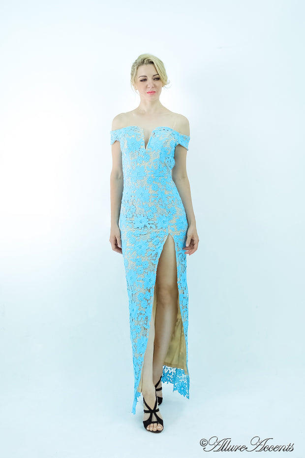Woman wearing a baby blue off-the-shoulder lace dress with a front slit. 