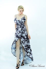 Women is wearing a black multi color floral maxi dress, sexy satin floral sundress with low-cut back with ruffles detail 