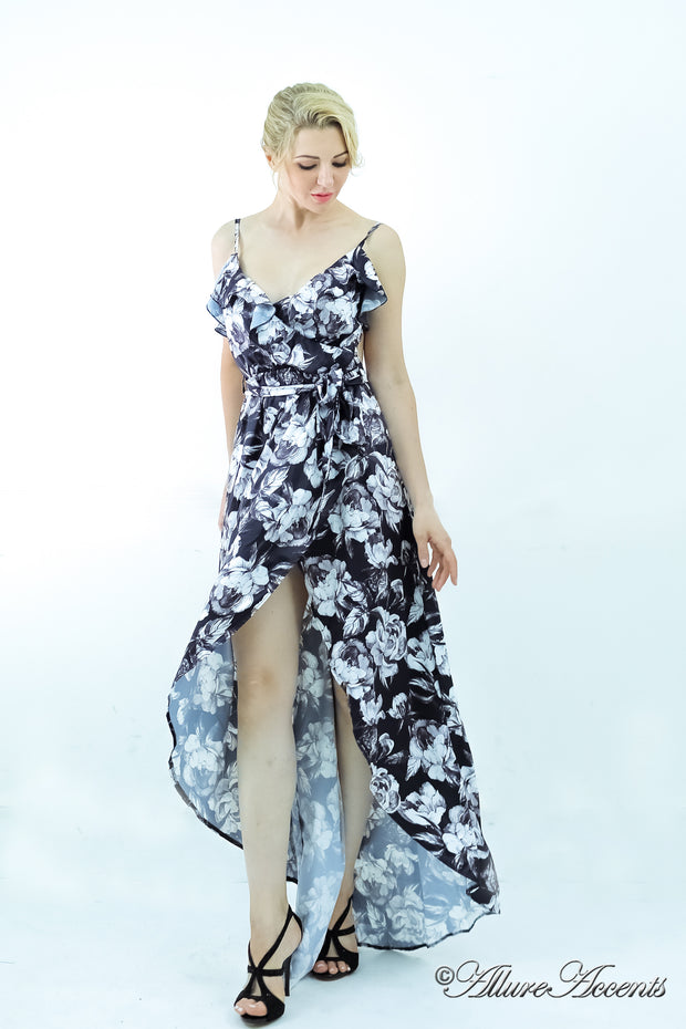 Women is wearing a black multi color floral maxi dress, sexy satin floral sundress with low-cut back with ruffles detail 
