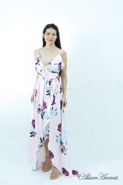 Women is wearing a blush multi color floral maxi dress, sexy satin floral sundress with low-cut back with ruffles detail 
