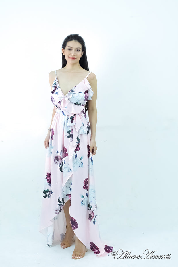 Women is wearing a blush multi color floral maxi dress, sexy satin floral sundress with low-cut back with ruffles detail 
