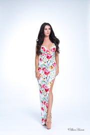 Woman wearing a white summer satin floral party maxi, low cut back and has sexy side slit 