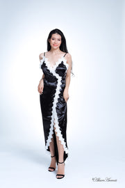 Woman wearing a black satin midi dress, low-cut back with lace details