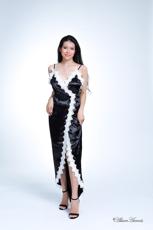 Woman wearing a black satin midi dress, low-cut back with lace details
