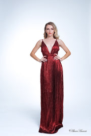 Woman wearing a red colored maxi length slip dress with a deep v neck.