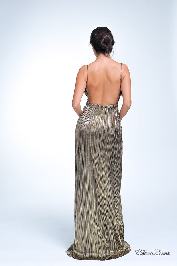 Woman wearing a gold long maxi length slip dress showing it has a low back cut.